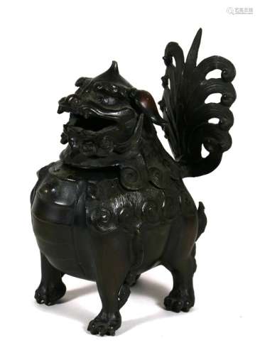 A Chinese bronze Buddhist lion dog incense burner 23cm (9 ins) high