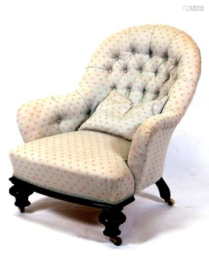 A Victorian upholstered tub chair on turned front supports.
