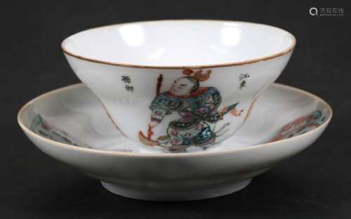 A Chinese tea bowl and saucer decorated figures and calligraphy, having a red seal mark to the