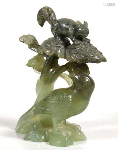 A Chinese carved jade group depicting a bird under a tree with a squirrel in the canopy, 12.5cms (