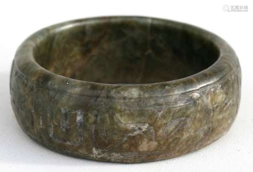 A Chinese archaic style figured green soapstone bangle, 9cms (3.5ins) diameter.
