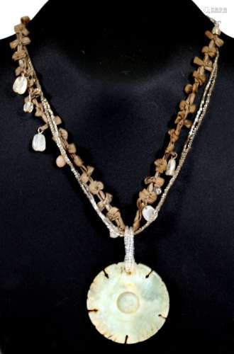 A Chinese jade like circular disc pendant, 5cms (2ins) diameter.