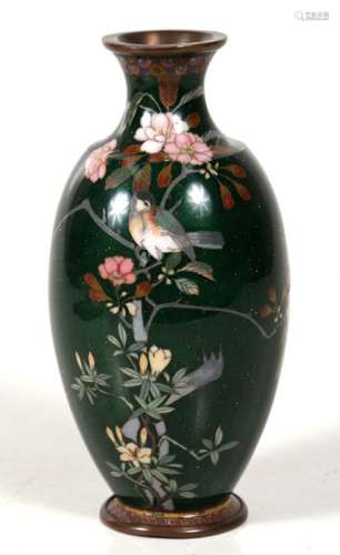 A Japanese silver wire cloisonne vase decorated with a bird in a flowering tree, on a gold flecked
