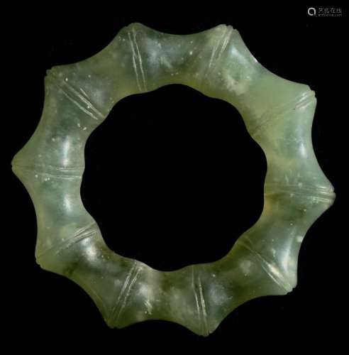 A jade / nephrite fluted pendant, 5cms (2ins) diameter.