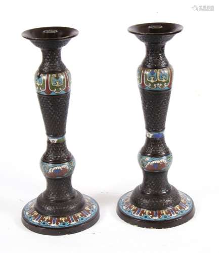 A pair of Chinese bronze & cloisonne enamel candlesticks, 36cms (14ins) high.