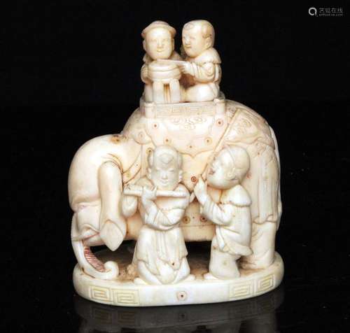 A 19th century Chinese carved ivory group depicting an elephant and boys, two-character mark to