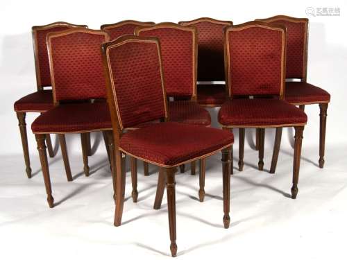 A set of eight French style dining chairs with upholstered seats and backs, on turned front