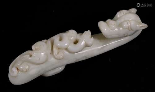 A Chinese figured pale green hardstone belt hook in the form of a dragon, 15cms (6ins) long.