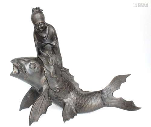 A Japanese bronze incense burner in the form of a scholar riding on the back of a carp, 26cms (10.