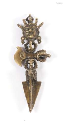 A Tibetan Phurba ceremonial dagger with mask finial, 15cms (6ins) long.