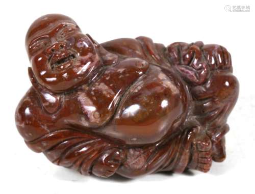 A Chinese carved jasper figure of a fat reclining Buddha, 9cms (3.5ins) wide.