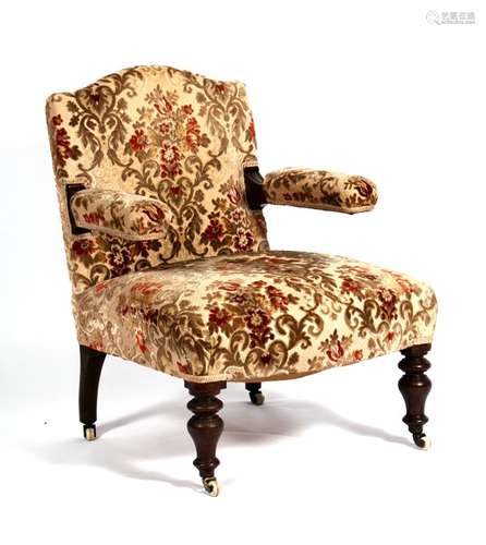 A Victorian open armed armchair with upholstered seat and back, on turned front supports.