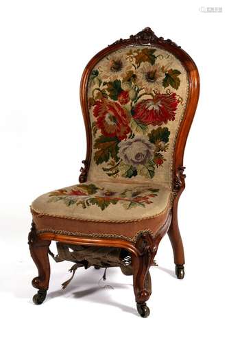 A Victorian walnut chair with needlepoint upholstered seat and back, on carved cabriole front