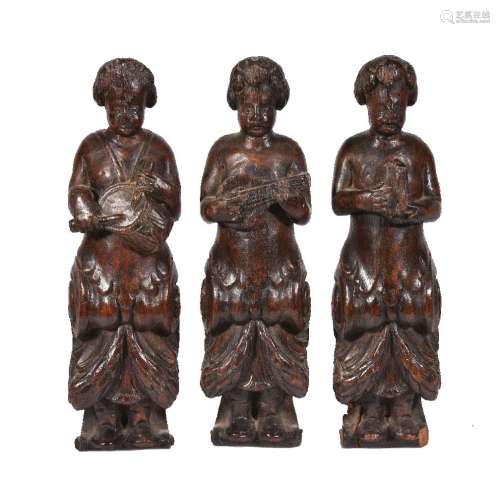 Three northern European carved term figures of musicians, late 17th century