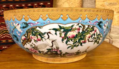 A large and impressive Chinese famille rose punch bowl, decorated with panels of Manchurian Cranes