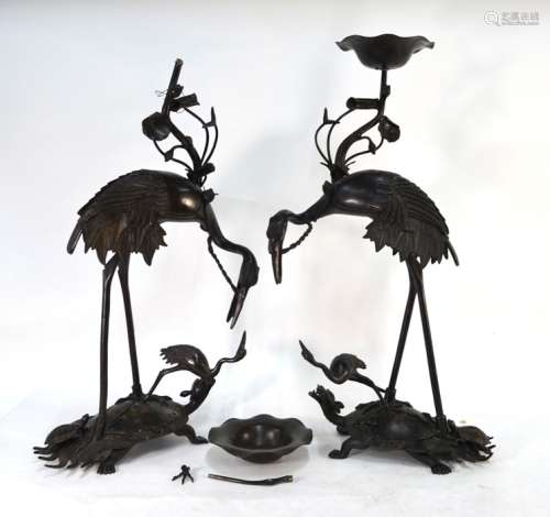 A pair of Japanese metal alloy figures of Manchurian tsuru; each bird standing on a minogame