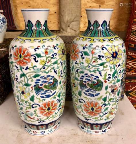 A pair of Chinese doucai slender, oviform vases; each one decorated with birds and formal floral