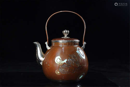 A SILVER TEAPOT