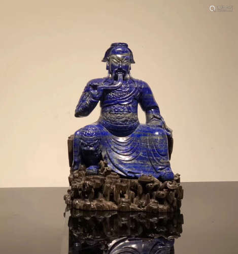 A LAZULI CARVED FIGURE SHAPED ORNAMENT WITH BASE