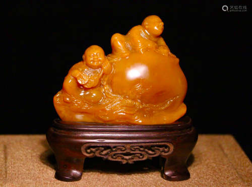A TIANHUANG STONE CARVED CHILD SHAPED PENDANT