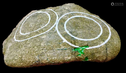 A BURMESE GREEN JADEITE STONE, A CLASS