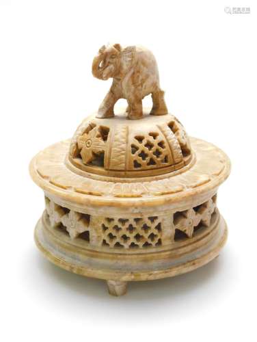 An Indian carved soapstone box, the removable lid with domed cover and elephant finial, finely