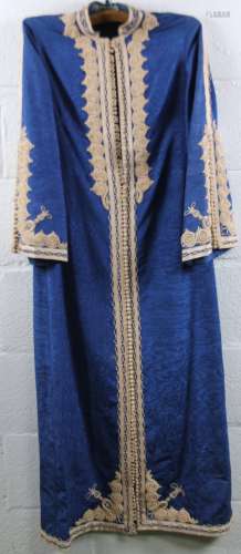An early 20thC oriental dress, full length in blue with raised frills and elaborate front fastening,