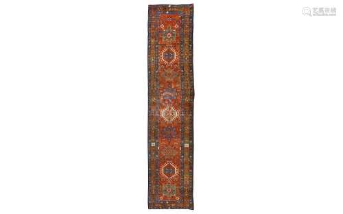 AN ANTIQUE HERIZ RUNNER, NORTH-WEST PERSIA approx: 14ft.3in. x 3ft.(434cm. x 91cm.) The field with