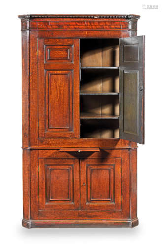 A late George III joined oak standing corner cupboard, circa 1790