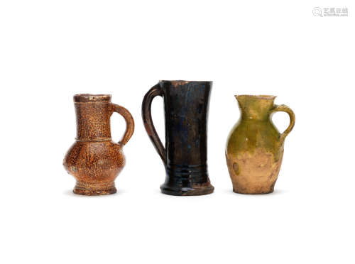 A Rhenish 'tigerware' jug, a Cistercian ware tyg and a border ware jug, 16th/17th century