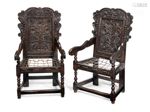 An extremely near pair of Charles II joined oak panel-back open armchairs, South-West Yorkshire, circa 1670