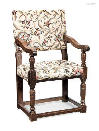 A James I joined walnut and upholstered open-armchair, circa 1620