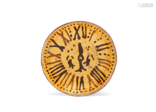 A Staffordshire or Yorkshire slipware clockface dish, circa 1715