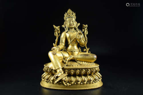 GILT BRONZE CAST 'GREEN TARA' SEATED FIGURE THE GILT BRONZE FIGURE DEPICTS GREEN TARA SEATED ON DOUBLE LOTUS THRONE PAD IN LALITASANA, HANDS RAISED IN MUDRA, WEARING ORNAMENTS AND CROWN WITH LOTUS FLOWER STEMMING FROM ARMS, EYES OPEN IN SERENE EXPRESSION, BOTTOM BEARS VAJRA MARK.