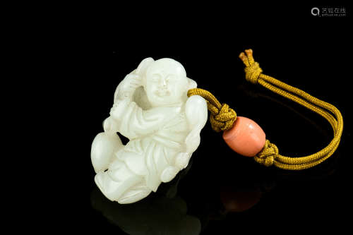 A CHINESE CARVED JADE ORNAMENT OF A BOY