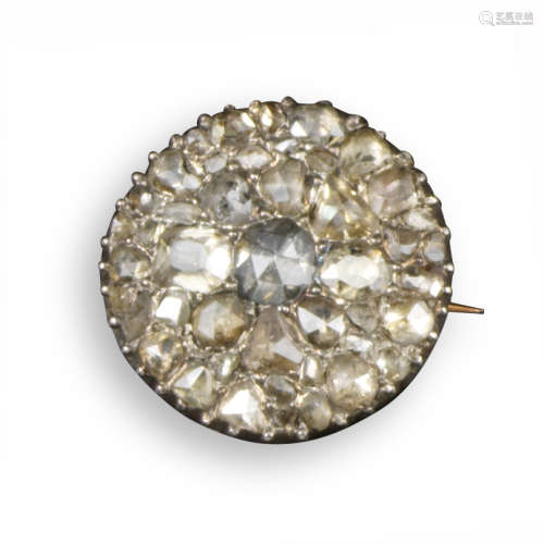A George III diamond-set circular brooch, pavé-set with rose-cut diamonds in silver on gold,