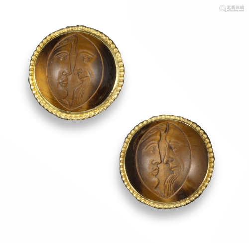 A pair of early 20th century tiger's eye cameo earrings, carved with two faces in profile within
