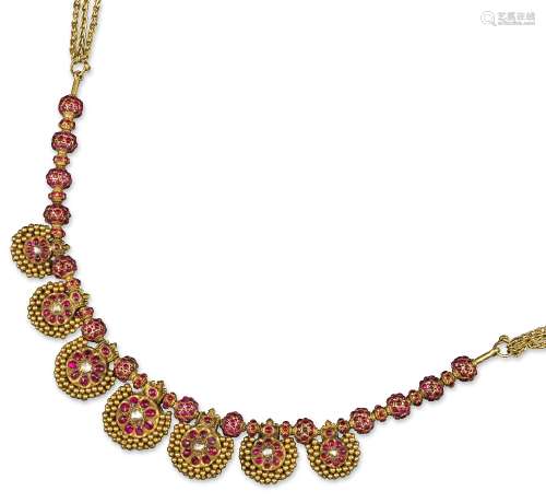 An Indian ruby and diamond-set gold necklace, the seven spherical pendants are each centred with a