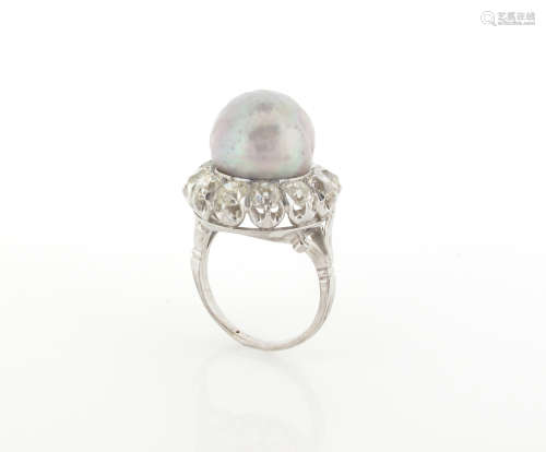 A natural pearl and diamond cluster ring, the grey pearl is set within a surround of cushion-