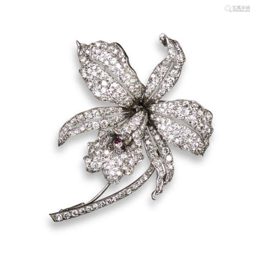 A diamond-set orchid brooch, realistically designed and pave-set with graduated circular-cut