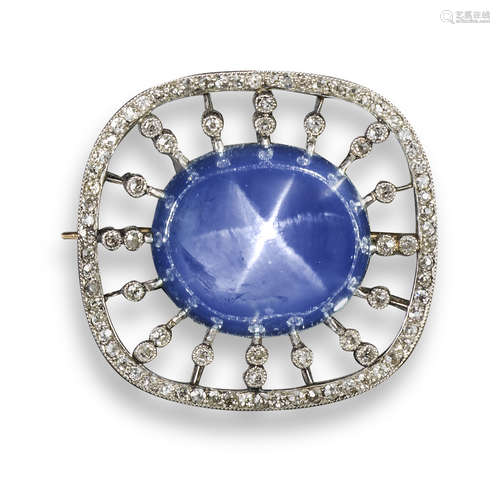 An Edwardian star sapphire and diamond brooch, the high-domed cabochon sapphire is set within a