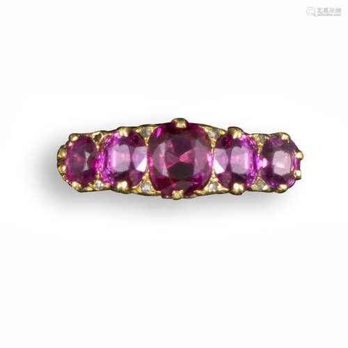 A ruby five-stone ring, the graduated cushion-shaped rubies set with diamond pointers in carved