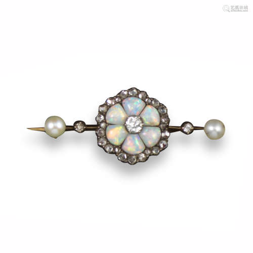 An Edwardian opal and diamond cluster brooch, designed as a flower head, with carved opal petals