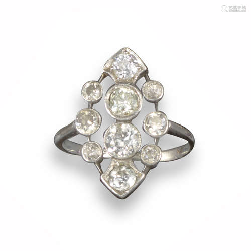 An Edwardian navette-shaped ring, pierced and millegrain-set with graduated old circular-cut