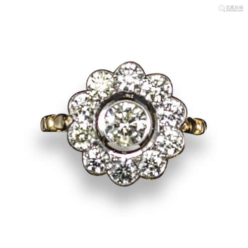 A diamond cluster ring, the centre round brilliant-cut diamond weighs approximately 0.50cts and is