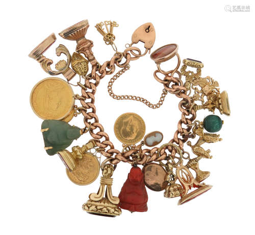 A gold charm bracelet, the curb-link bracelet suspends assorted charms including three gold coins,