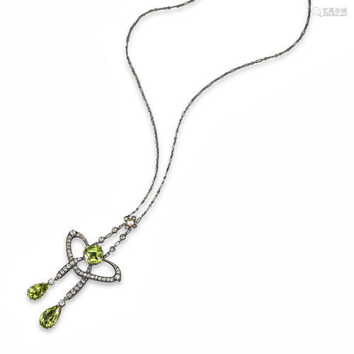 A Victorian peridot and diamond pendant, set with a cushion-shaped peridot within scrolling