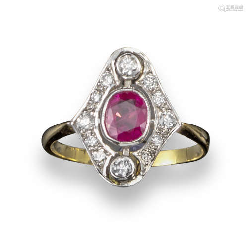 A ruby and diamond cluster ring, the oval-shaped ruby set within an openwork surround set with round