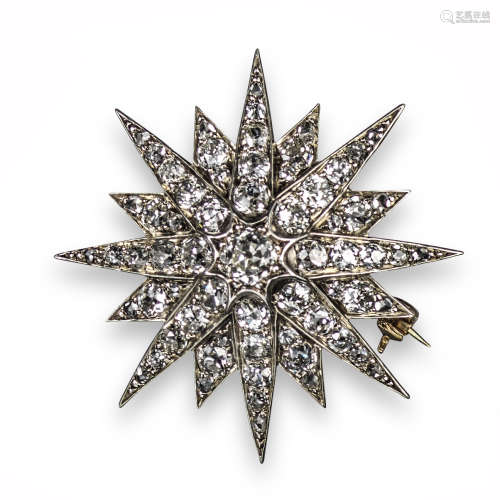 A late 19th century diamond starburst brooch pendant, set with graduated old cushion-shaped diamonds