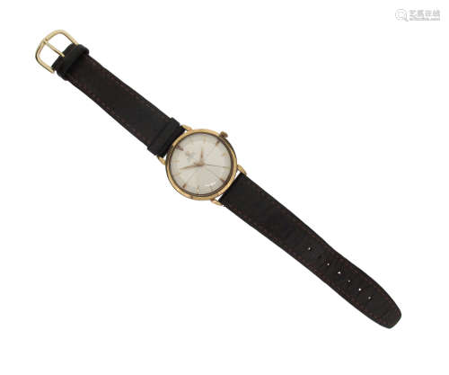 A gentleman's 9ct wrist watch by Omega, silvered cross-hair dial with gold hour markers. Signed